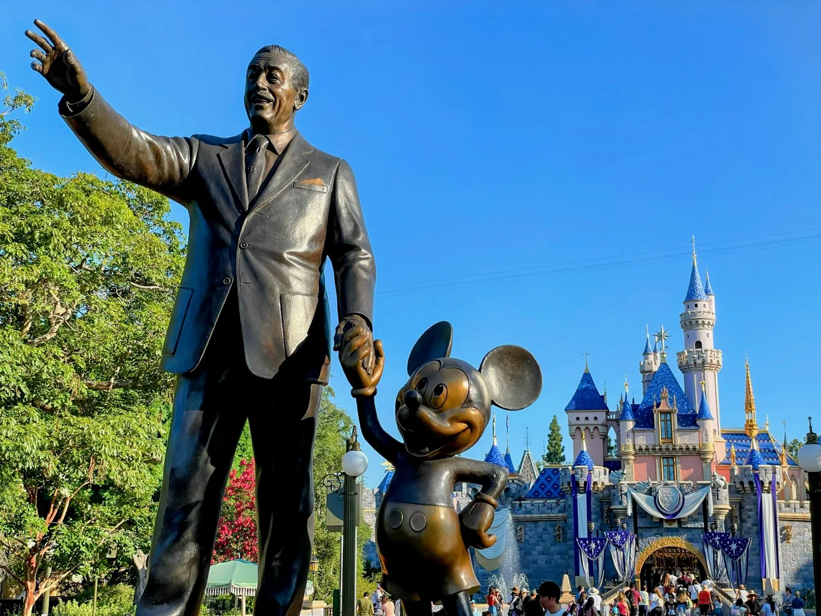 Sleeping Beauty Castle behind the Partners statue at Disneyland Park in Anaheim
